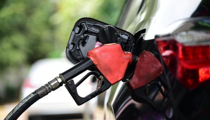 Close up of Refueling Car fill with petrol gasoline at gas station and Petrol pump filling fuel nozzle in fuel tank of car