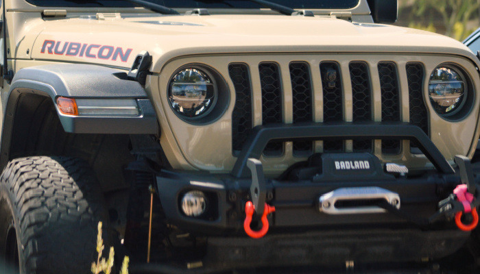 Jeep offroad vehicle with after market electric winch, loop bar, and bumper mounted on the front